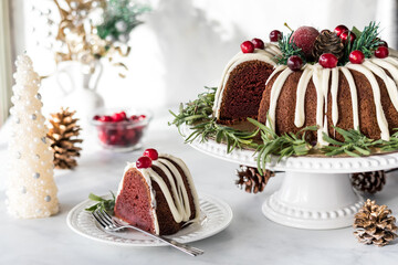 A festive decorated bundt cake with one serving to the side.