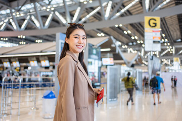 Portrait of Asian young girl walk in airport terminal to boarding gate. 