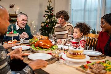 Multi-ethnic big family celebrating Christmas party together in house.