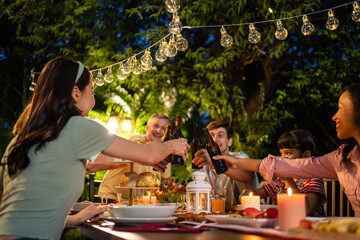 Multi-ethnic big family having fun, enjoy party outdoors in the garden. 