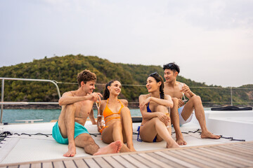 Group of diverse friends drink champagne while having a party in yacht. 