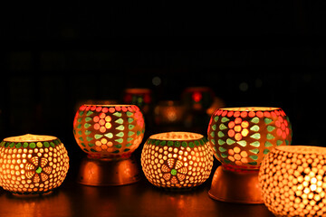 Diwali celebration Indian festival of lights Diya oil lamp lantern. Colors Rangoli decoration...