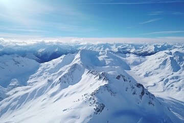 Aerial view of an untouched snowy mountain range under clear blue skies