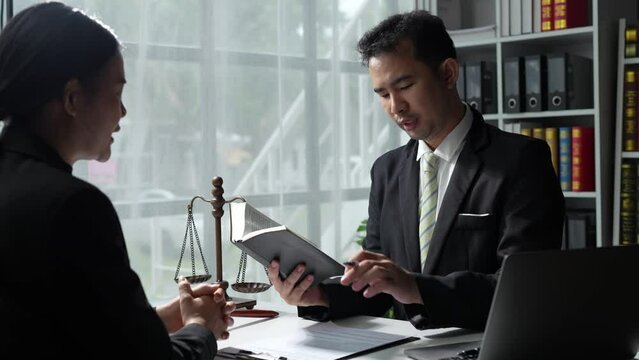 Lawyer reads law code, studies constitution to protect human rights before business contract signing, male lawyer or judge working with hammer of justice law book.