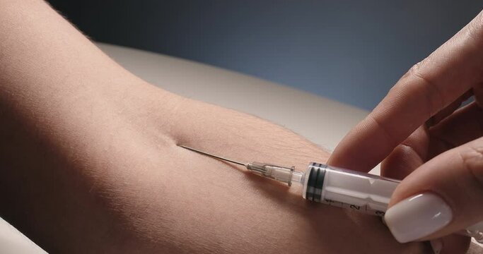 Vein is pierced by a needle for the removal of blood. Close-up