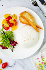 mozzarella with spinach, cherry tomatoes, wild berries and bread side view