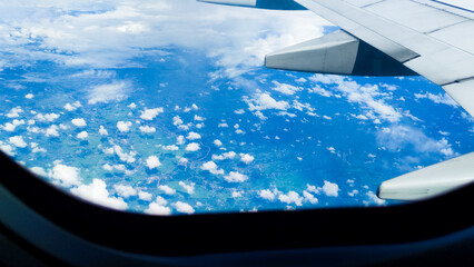 Beautiful nature of beauty sky and clouds through an airplane window. Travel concept, traveler, trip, vacation, tourism, background