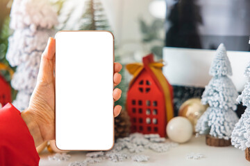 Gentle hands cradle a smartphone with a white screen mock up  by festive scene a beautiful...