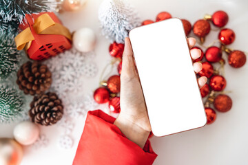 Top view Gentle hands cradle a smartphone with a white screen mock up  by festive scene a beautiful...