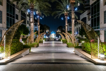 Night view to decorative illuminated pedestrian alley at Dubai Marina in Dubai city, United Arab Emirates