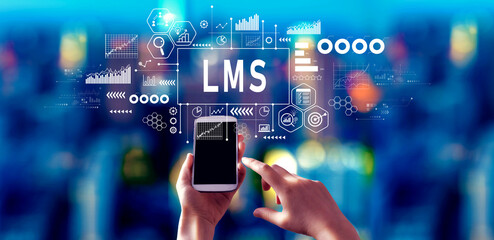 LMS - Learning Management System with person using a smartphone in a city at night