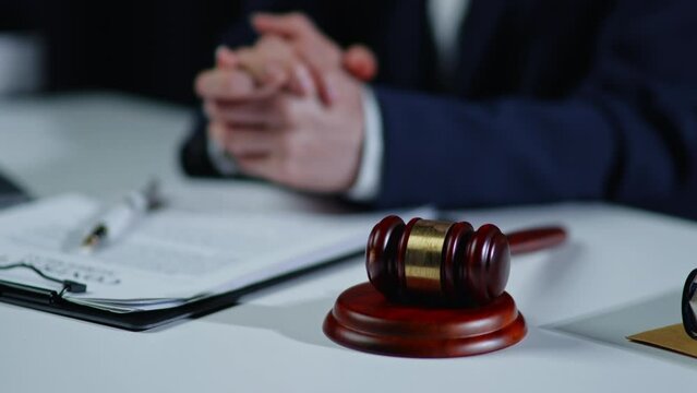  Lawyer explain and discuss matters of law and contract to clients and hit gavel hammer.