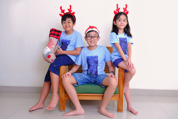 The happiness of children wearing reindeer horns on their heads and presents from Santa Claus