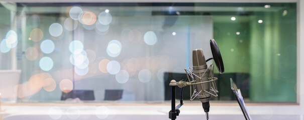 Studio microphone and pop shield on mic in the empty recording studio. Professional microphone close up in recording studio. Microphone in a recording studio