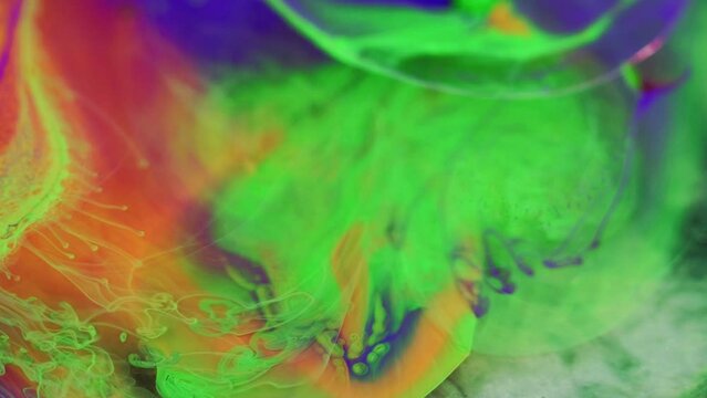 Abstract background. Paint mix bubbles. Colorful fluid art. Bright purple blue green orange blot spreading motion in hypnotic creative liquid oil design.