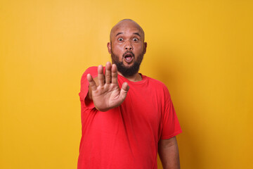 Bearded fat man showing stop or rejection hand sign gesture