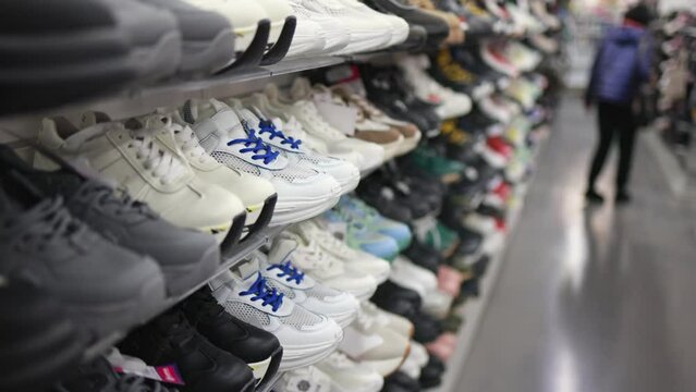 Shelves with sneakers in a store.