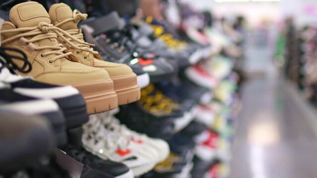 Rack with boots in a shopping center.