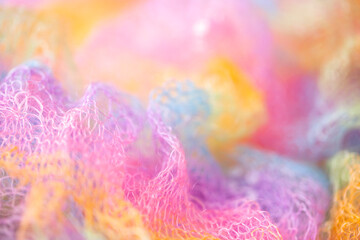 Knitted surface woolen items rainbow colored as a background. Closeup of soft multicolored knitted...