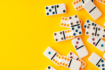 Domino tiles on yellow background studio shot