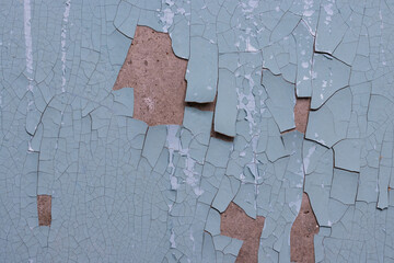 Peeling paint on the wall. Old concrete wall with cracked flaking paint. Weathered rough painted...