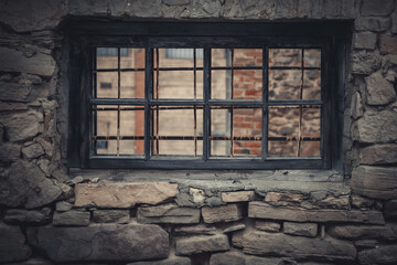 Weathered Abandoned Building Exterior with Damaged Walls and Old Windows. Place of imprisonment, Prison with the old window - obrazy, fototapety, plakaty