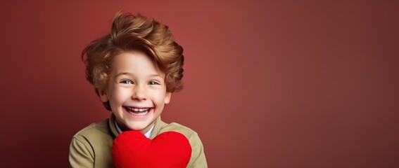 Happy little boy with red hearts on Valentine's Day.