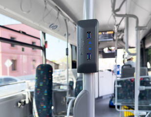 USB charging outlet or socket on a public transport bus in Europe. USB port slot charger in public...