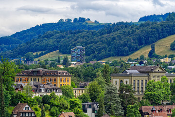 Fototapeta na wymiar Scenic view of mountain panorama and woodland with local mountain Gurten seen from the old town of City of Bern on a cloudy summer day. Photo taken July 1st, 2023, Bern, Switzerland.