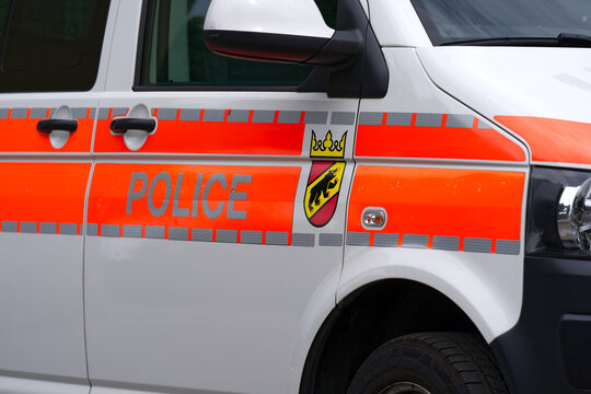 Close-up of police car with coat of arms at the old town of Swiss City of Bern on a cloudy summer day. Photo taken July 1st, 2023, Bern, Switzerland.