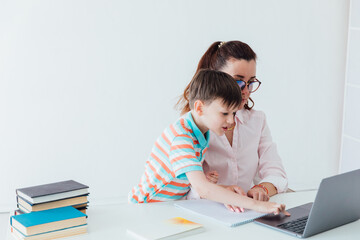 Woman with boy playing laptop online