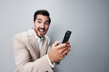 man hold portrait phone confident call smile business suit smartphone happy