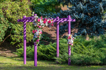 Front view of a decorative pink pergola with artificial flowers in urban garden, closeup - Powered by Adobe