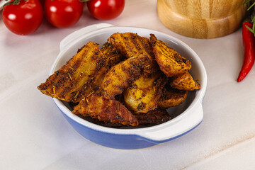 Golden baked potato Idaho with spices