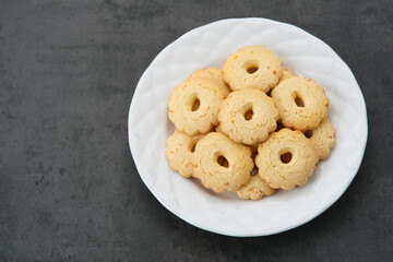 Kue Keju or Cheese cookies. Served on white plate
