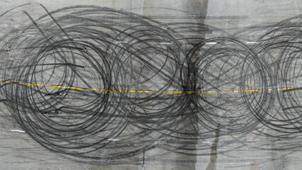 Aerial view tire track mark on asphalt tarmac road race track texture and background, Abstract background black tire track skid on asphalt road, Tire mark skid mark on asphalt road.