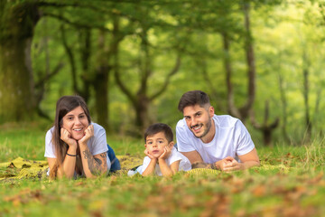 Fototapeta premium Portrait of a happy family lying on the grass