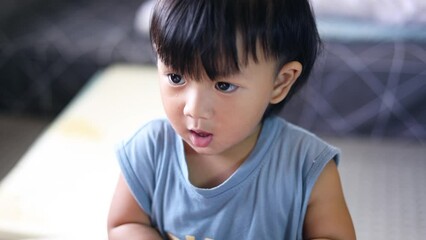 Boy putting toy car in his mouth while teething.