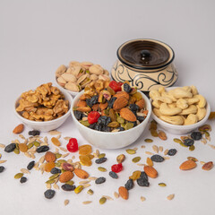Mixed nuts on white bowl with white background, mixed dry fruits and nuts on white bowl with white background