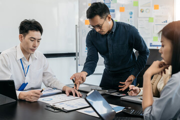 Group of Asian business people, teamwork, people and crisis concept - business team sitting sad and solving problems in the office.