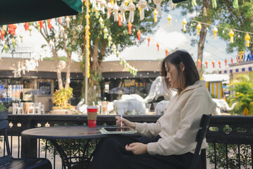 digital nomad concept asian freelancer woman use laptop to work at outdoor of coffeeshop