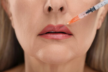 Senior woman getting lips injection, closeup. Cosmetic surgery