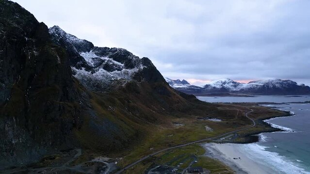 View over flakstad beach. Surfers arctic paradais. This place atracts a lot of people from all over the world. This is an areal video of mountains and beach