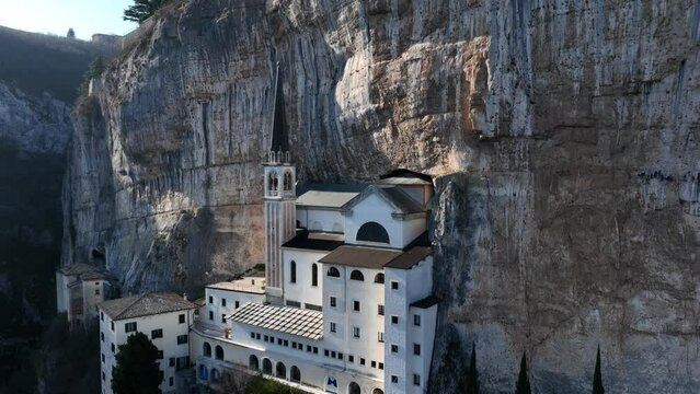 Madonna della Corona Sanctuary - Drone Shot from Side back flying over rooftop - Iconic view of the most famous church in the world - Madonna della Corona - Spiazzi - Verona - Ungraded