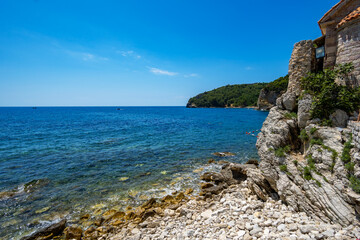 view of the fortress and the old town on the seashore and mountains, panorama of the Budva resort in Montenegro, Adriatic Sea, beaches, islands, tourism and summer travel