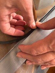 Close-up of Hand Repairing Screen Mesh