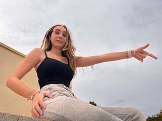 Young Woman Pointing to the Sky