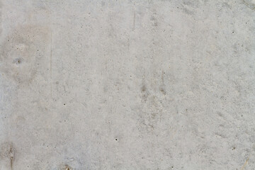 Texture of a gray concrete wall with small brown splashes. Background