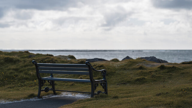 A special place: bench standing close to the beach with a view over the ocean, moody scene