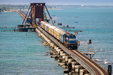 Indian Railways passenger train crossing historical , 2 kms long Pamban sea bridge.